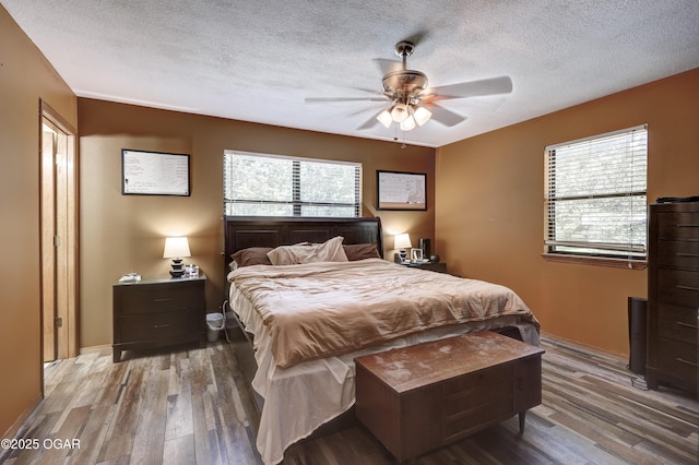 5223 County Lane 301, Joplin, MO 64801 - bedroom with wood finished floors, a textured ceiling, and a ceiling fan