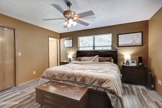 5223 County Lane 301, Joplin, MO 64801 - bedroom with light wood finished floors, a textured ceiling, and ceiling fan