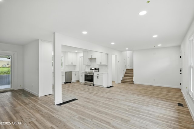12807 Larissa Ln, Neosho, MO 64850 - unfurnished living room with recessed lighting, light wood-type flooring, and stairs