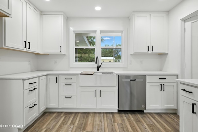 12807 Larissa Ln, Neosho, MO 64850 - kitchen with stainless steel dishwasher, recessed lighting, light countertops, white cabinets, and light wood finished floors