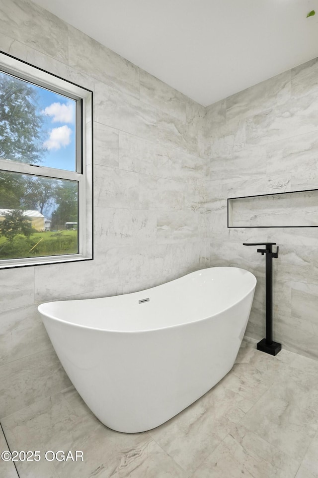 12807 Larissa Ln, Neosho, MO 64850 - full bath featuring a freestanding tub, marble finish flooring, and tile walls