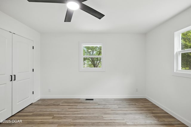 12807 Larissa Ln, Neosho, MO 64850 - unfurnished bedroom with light wood finished floors, a ceiling fan, and a closet