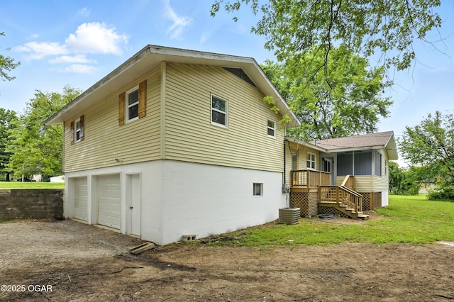 12807 Larissa Ln, Neosho, MO 64850 - back of house with driveway, stairway, a garage, and a sunroom