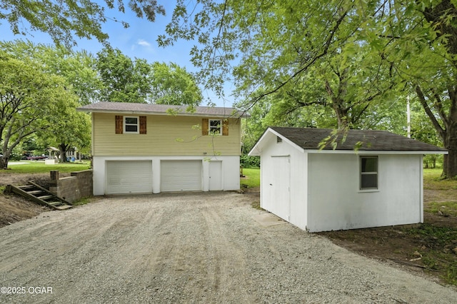 12807 Larissa Ln, Neosho, MO 64850 - view of front of house featuring driveway, a garage, and an outdoor structure
