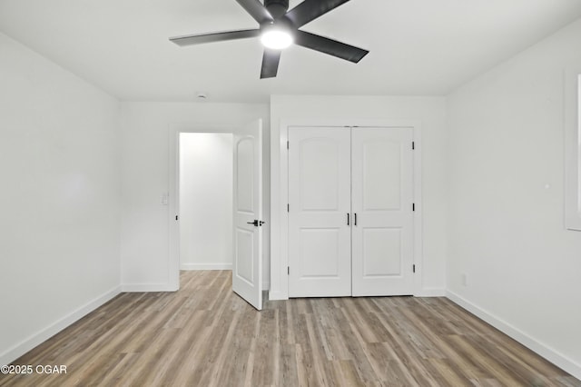 12807 Larissa Ln, Neosho, MO 64850 - unfurnished bedroom with light wood-style floors, a closet, and a ceiling fan