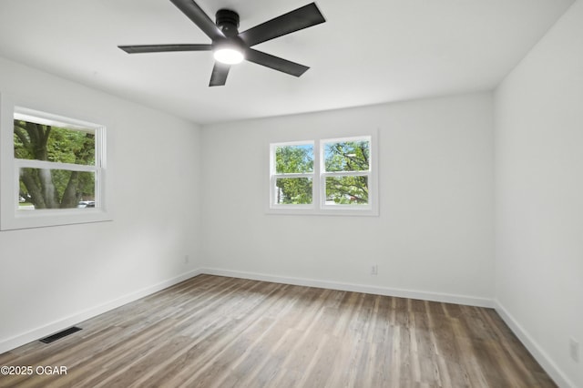 12807 Larissa Ln, Neosho, MO 64850 - unfurnished room featuring wood finished floors and ceiling fan