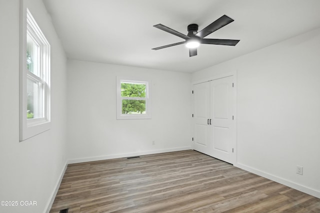 12807 Larissa Ln, Neosho, MO 64850 - unfurnished bedroom featuring wood finished floors, a closet, and ceiling fan