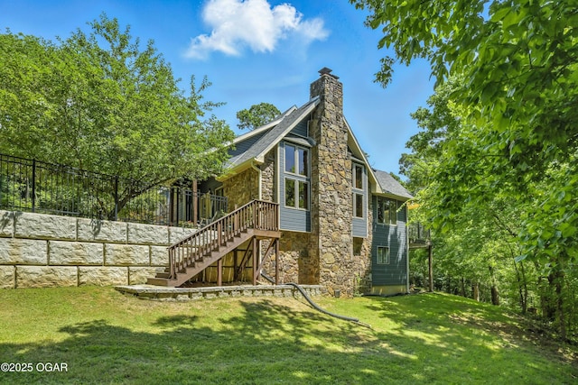 3310 Tana St, Joplin, MO 64804 - rear view of property with stone siding, stairs, a chimney, and a wooden deck