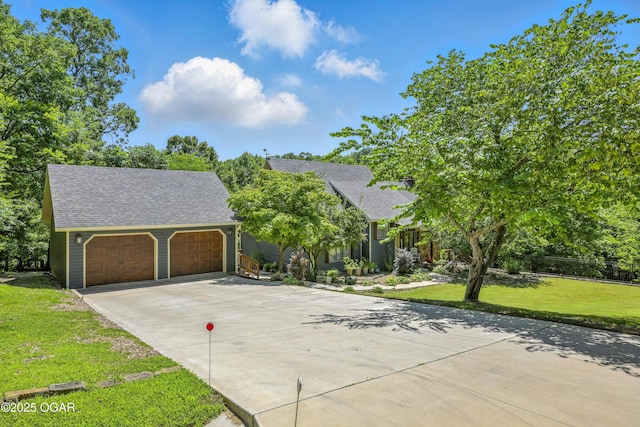 3310 Tana St, Joplin, MO 64804 - view of front of property with a garage, a front yard, and roof with shingles