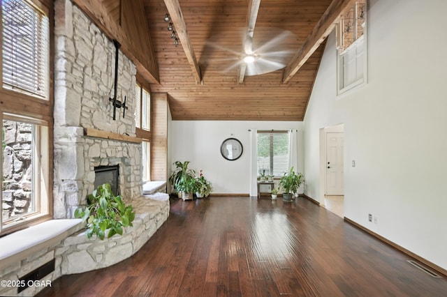 3310 Tana St, Joplin, MO 64804 - living room featuring ceiling fan, high vaulted ceiling, a wood ceiling with exposed beams, a stone fireplace, and hardwood / wood-style floors