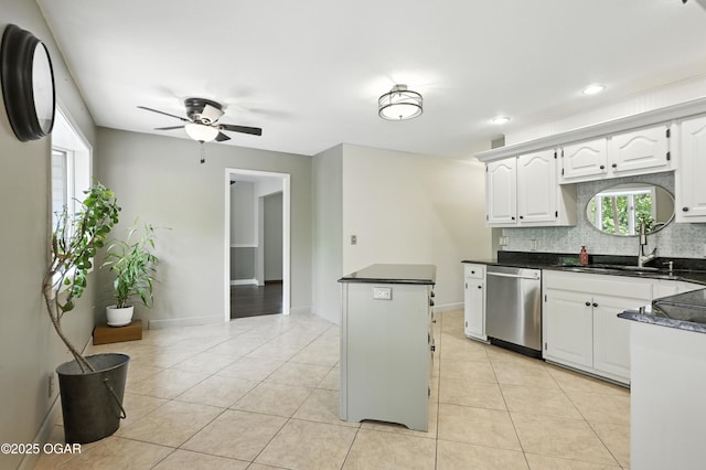 3310 Tana St, Joplin, MO 64804 - kitchen with dishwasher, decorative backsplash, ceiling fan, white cabinetry, and light tile patterned floors