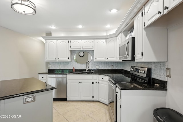 3310 Tana St, Joplin, MO 64804 - kitchen with appliances with stainless steel finishes, dark countertops, white cabinetry, backsplash, and light tile patterned floors
