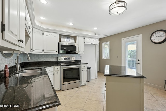 3310 Tana St, Joplin, MO 64804 - kitchen with stainless steel appliances, decorative backsplash, light tile patterned floors, dark stone countertops, and recessed lighting