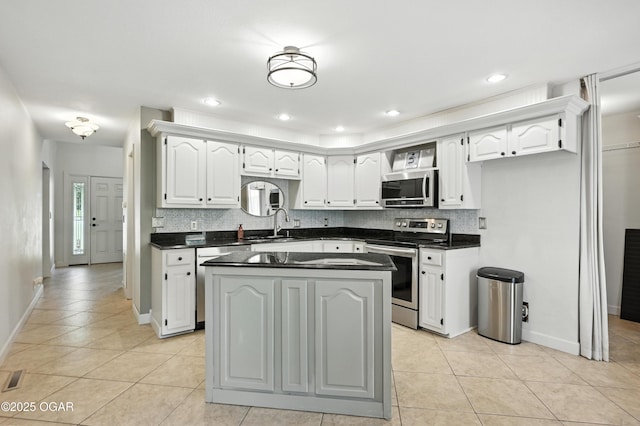 3310 Tana St, Joplin, MO 64804 - kitchen with appliances with stainless steel finishes, dark countertops, light tile patterned floors, and recessed lighting