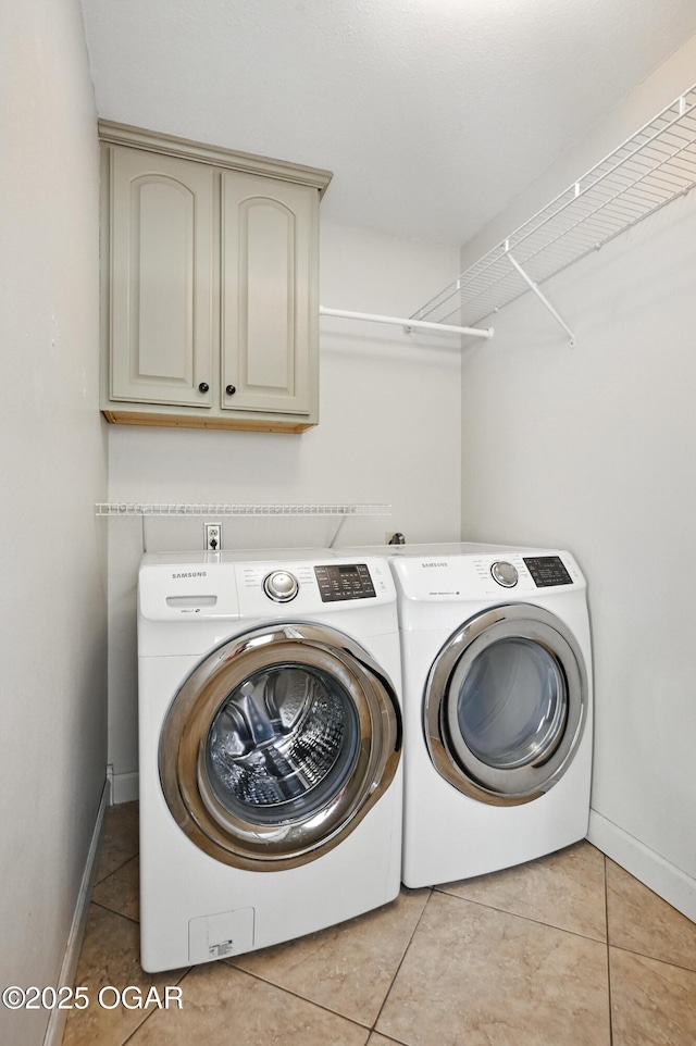 3310 Tana St, Joplin, MO 64804 - laundry room with washing machine and dryer, cabinet space, and light tile patterned flooring