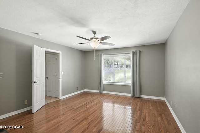 3310 Tana St, Joplin, MO 64804 - spare room featuring wood finished floors, a ceiling fan, and a textured ceiling