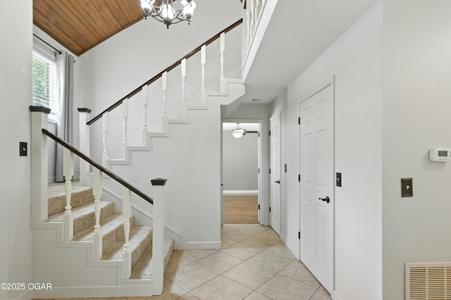 3310 Tana St, Joplin, MO 64804 - staircase featuring tile patterned floors, wooden ceiling, a chandelier, vaulted ceiling, and a ceiling fan
