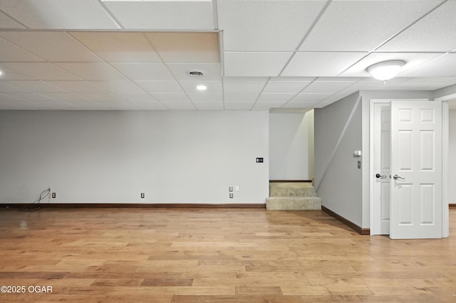 3310 Tana St, Joplin, MO 64804 - below grade area with light wood finished floors, stairway, and a drop ceiling