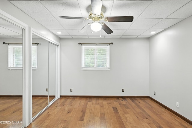 3310 Tana St, Joplin, MO 64804 - unfurnished bedroom featuring wood finished floors, a paneled ceiling, two closets, and ceiling fan