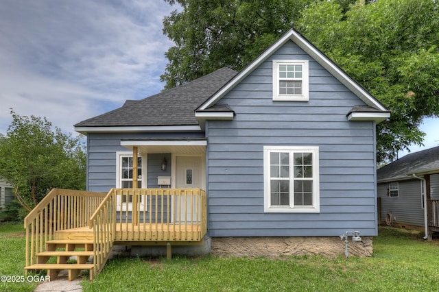 1908 S Picher, Joplin, MO 64804 - view of front of home featuring roof with shingles, a deck, and a front lawn