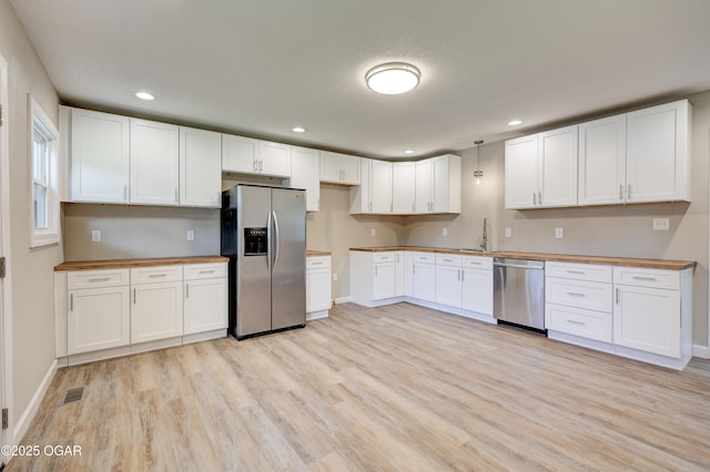 1908 S Picher, Joplin, MO 64804 - kitchen featuring appliances with stainless steel finishes, light wood finished floors, recessed lighting, white cabinets, and pendant lighting