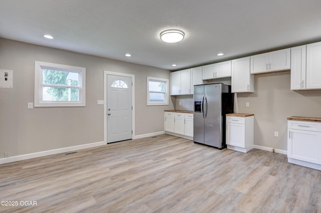 1908 S Picher, Joplin, MO 64804 - kitchen featuring stainless steel fridge, healthy amount of natural light, white cabinetry, light wood-type flooring, and recessed lighting
