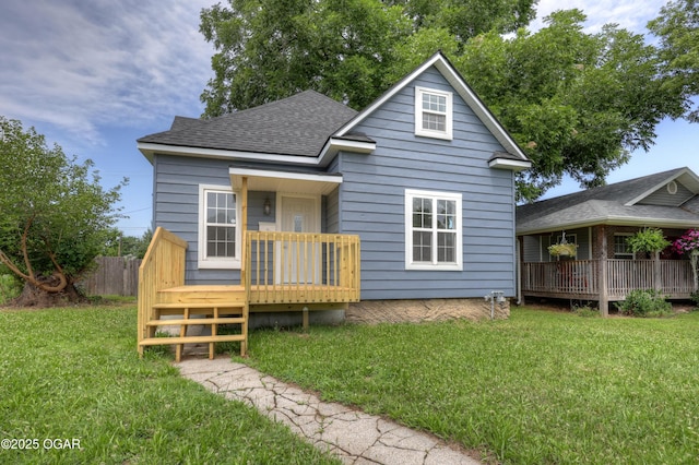 1908 S Picher, Joplin, MO 64804 - view of front of house with a wooden deck, a front yard, and roof with shingles