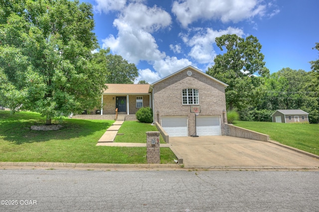 121 Fawn Trl, Seneca, MO 64865 - view of front of property with a garage, brick siding, driveway, and a front yard