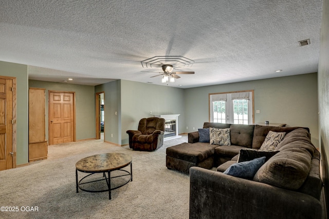 121 Fawn Trl, Seneca, MO 64865 - living room with a ceiling fan, carpet floors, a glass covered fireplace, french doors, and a textured ceiling