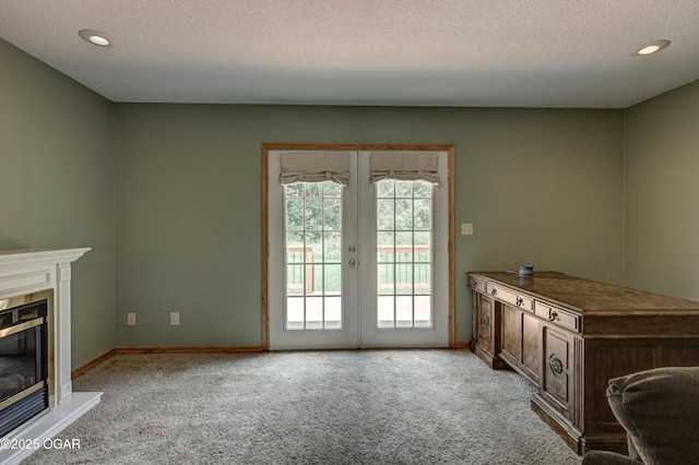 121 Fawn Trl, Seneca, MO 64865 - unfurnished living room featuring light carpet, a textured ceiling, french doors, a glass covered fireplace, and recessed lighting