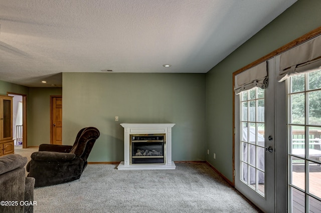 121 Fawn Trl, Seneca, MO 64865 - unfurnished living room with a textured ceiling, a glass covered fireplace, carpet flooring, and recessed lighting