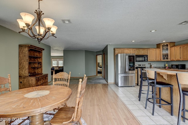 121 Fawn Trl, Seneca, MO 64865 - dining area with a chandelier, a textured ceiling, light wood-type flooring, and recessed lighting
