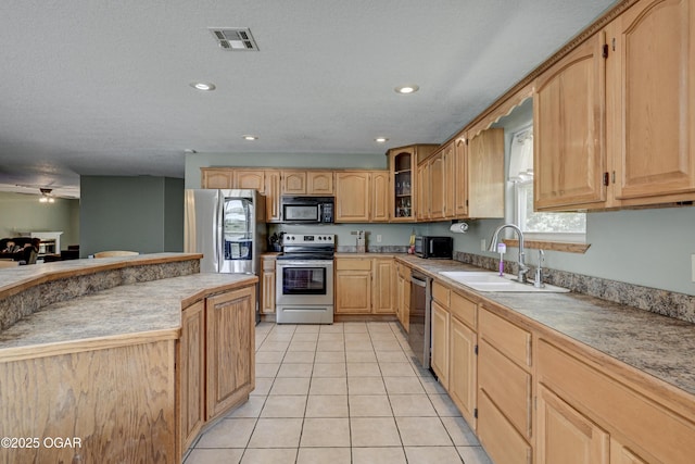 121 Fawn Trl, Seneca, MO 64865 - kitchen featuring appliances with stainless steel finishes, glass insert cabinets, light brown cabinets, light tile patterned floors, and light countertops