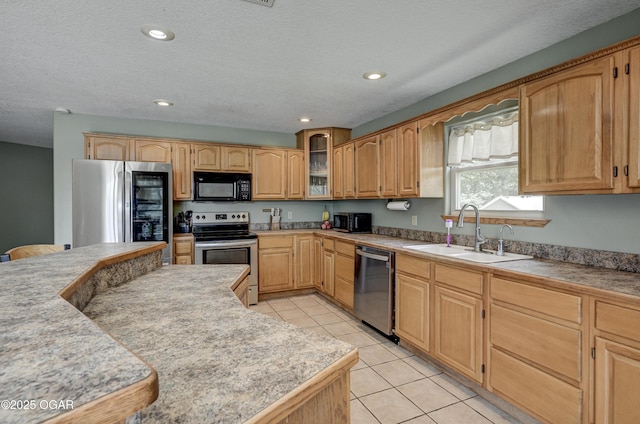 121 Fawn Trl, Seneca, MO 64865 - kitchen featuring appliances with stainless steel finishes, light tile patterned flooring, glass insert cabinets, light countertops, and recessed lighting