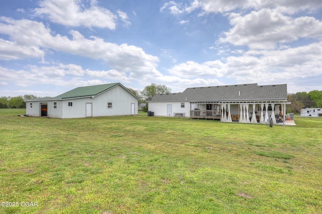 23841 Jaguar Rd, Oronogo, MO 64855 - rear view of property with a lawn, a wooden deck, an outbuilding, and a pole building