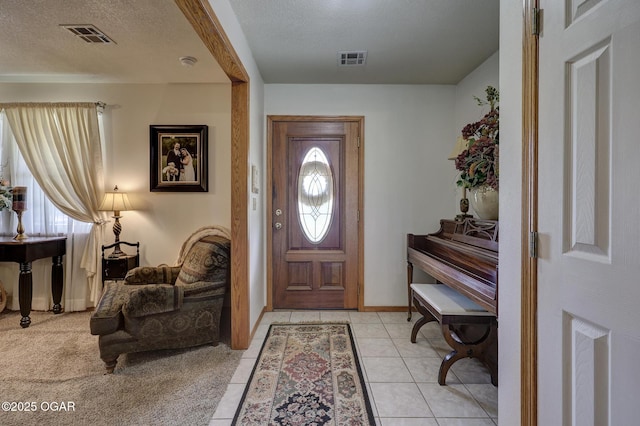 23841 Jaguar Rd, Oronogo, MO 64855 - foyer featuring plenty of natural light, a textured ceiling, and light tile patterned flooring