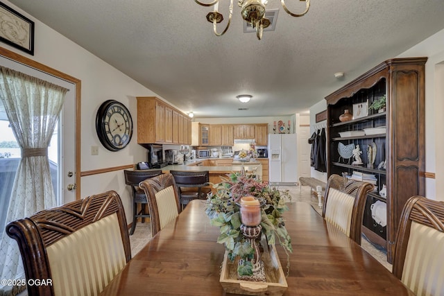 23841 Jaguar Rd, Oronogo, MO 64855 - dining area featuring a chandelier and a textured ceiling
