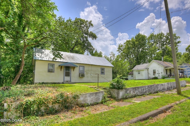 712 Joplin St, Sarcoxie, MO 64862 - view of front of home featuring a metal roof, a front lawn, and cooling unit