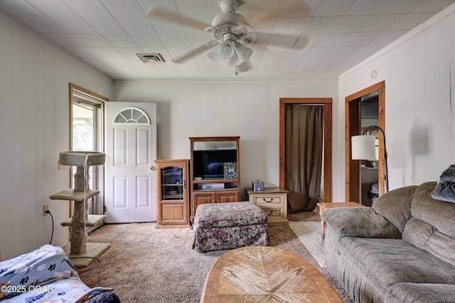 712 Joplin St, Sarcoxie, MO 64862 - living area with carpet floors, ornamental molding, a ceiling fan, and wood walls