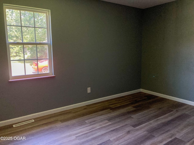 1212 W 12th St, Joplin, MO 64801 - unfurnished room featuring healthy amount of natural light and dark wood-style floors