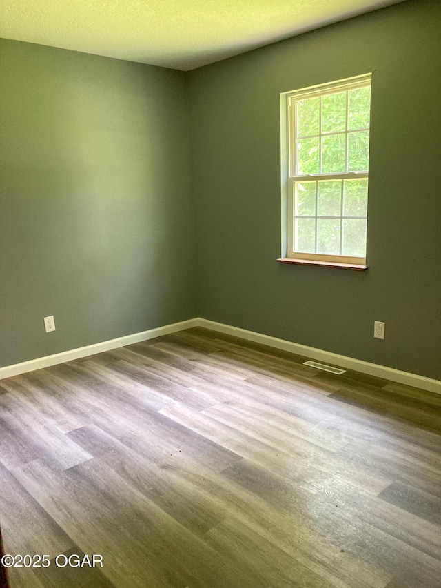 1212 W 12th St, Joplin, MO 64801 - spare room featuring baseboards and wood finished floors