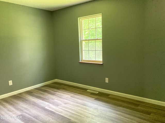 1212 W 12th St, Joplin, MO 64801 - empty room with wood finished floors