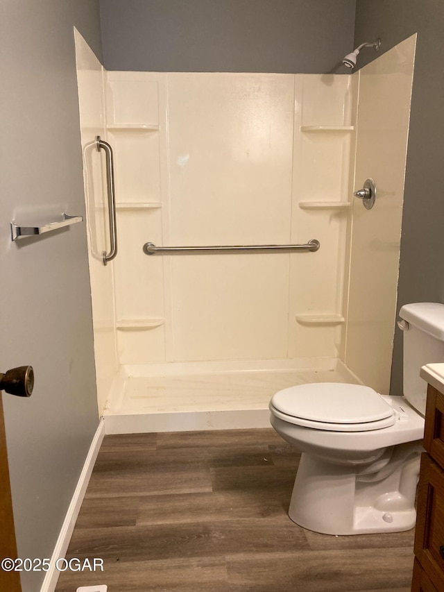 1212 W 12th St, Joplin, MO 64801 - full bath with wood finished floors, a shower stall, and vanity