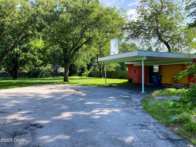 25399 Demott Dr, Joplin, MO 64801 - view of parking / parking lot featuring asphalt driveway and an attached carport