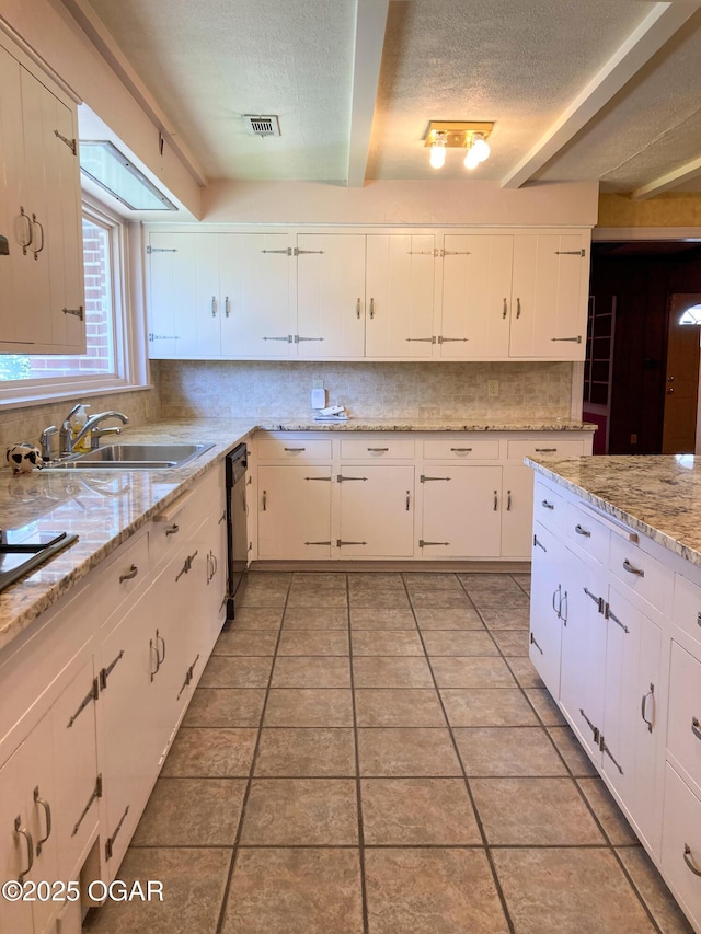 25399 Demott Dr, Joplin, MO 64801 - kitchen featuring decorative backsplash, a textured ceiling, dishwasher, light tile patterned floors, and white cabinets