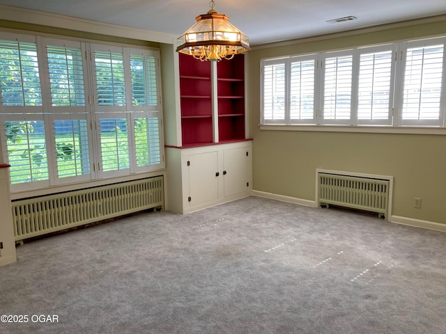 25399 Demott Dr, Joplin, MO 64801 - unfurnished room featuring radiator, a chandelier, carpet flooring, and crown molding