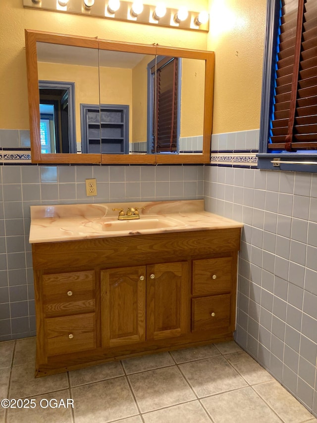25399 Demott Dr, Joplin, MO 64801 - bathroom with tile walls, vanity, tile patterned floors, and wainscoting