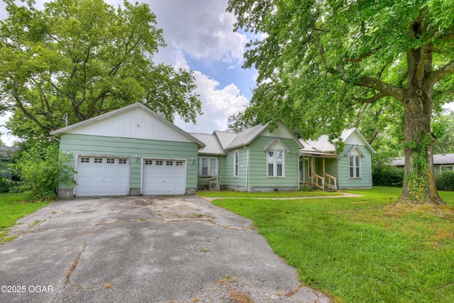 302 E Market St, Diamond, MO 64840 - ranch-style house featuring driveway, an attached garage, a front lawn, and a metal roof