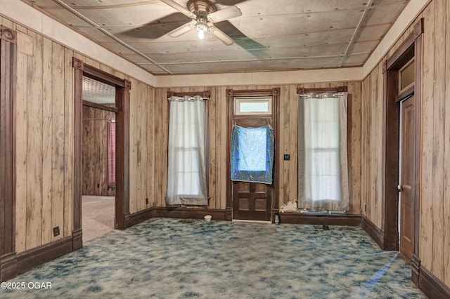 302 E Market St, Diamond, MO 64840 - carpeted foyer featuring wood walls and a ceiling fan