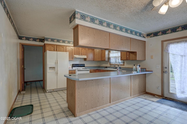 302 E Market St, Diamond, MO 64840 - kitchen with white appliances, under cabinet range hood, light flooring, a textured ceiling, and a peninsula